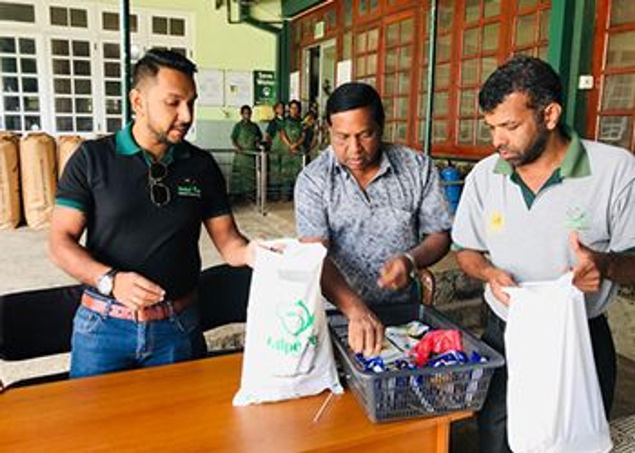 Three males packing charity donation gift bags